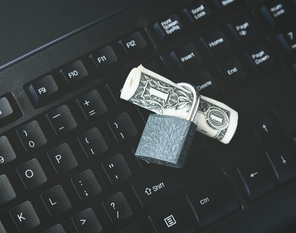 high-angle-shot-lock-around-dollar-bill-black-laptop